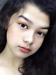 Slim oriental dame is revealing her breasts